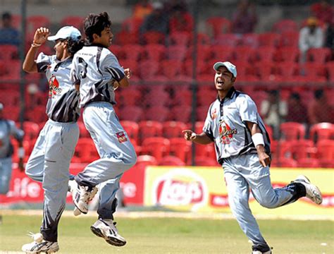 Cricketers from the Karnataka State Cricket Association XI celebrate ...