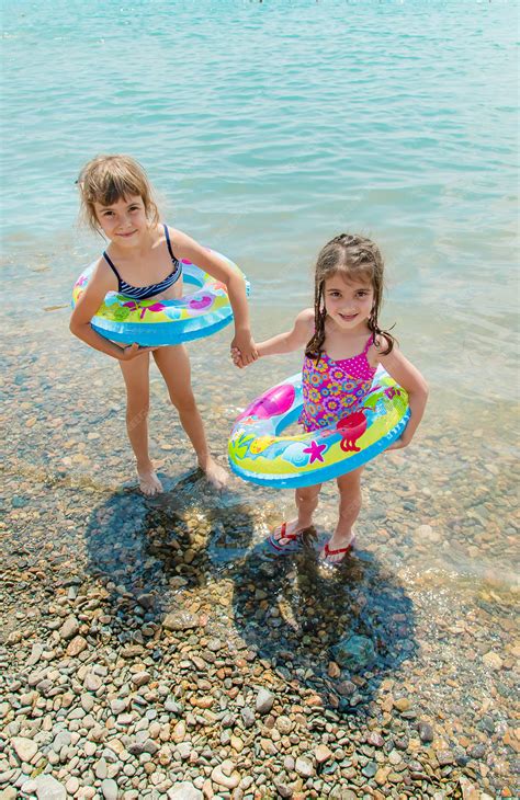 Premium Photo | Children swimming in the lake.