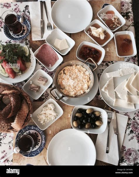 Turkish breakfast including scrambled eggs, olives, salami, cheese ...