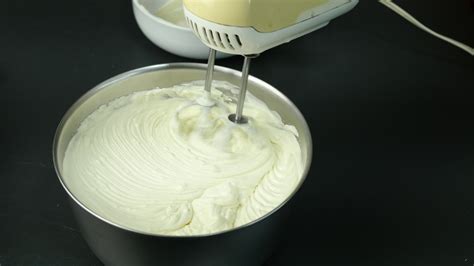 Chef is making cream cake using electric portable hand mixer machine ...