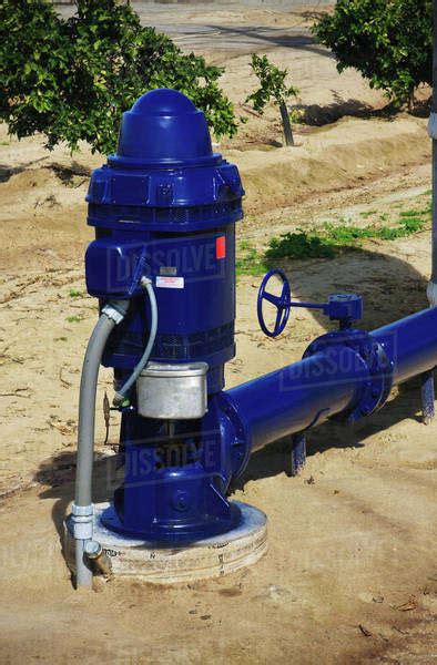 Agriculture - Closeup of an electric powered irrigation water pump in an orange grove / near ...