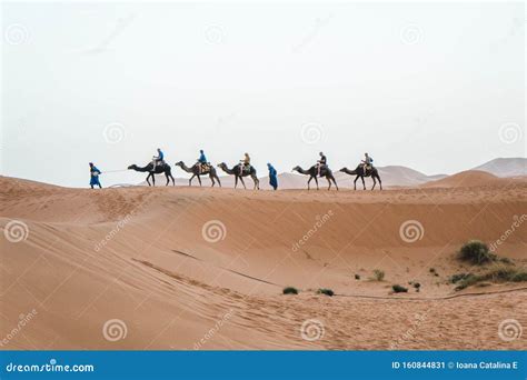 Merzouga, Morocco - APRIL 29 2019: View of Tourists on a Camel Ride ...