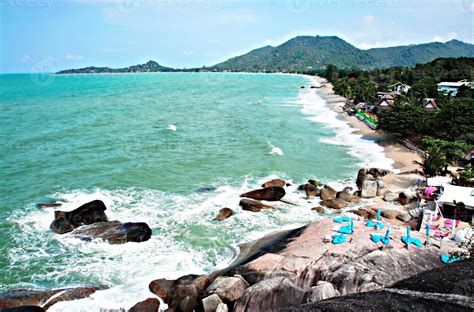 views of the Gulf of Thailand, blue sea, beach with sun loungers and tropical vegetation and ...