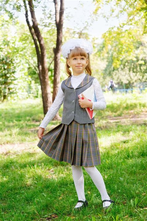 A First-grader Girl in a Beautiful Elegant Modern School Uniform on the ...