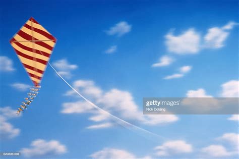 Red And Yellow Striped Kite Flying In Blue Sky High-Res Stock Photo - Getty Images