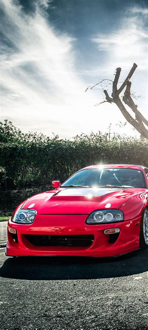 Red Toyota Supra cars under trees in nature 4K wallpaper download