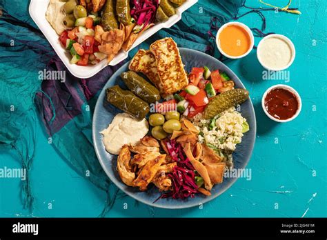 Loaded sharing portion of traditional Eastern Mediterranean Arabic food of hummus, olives ...