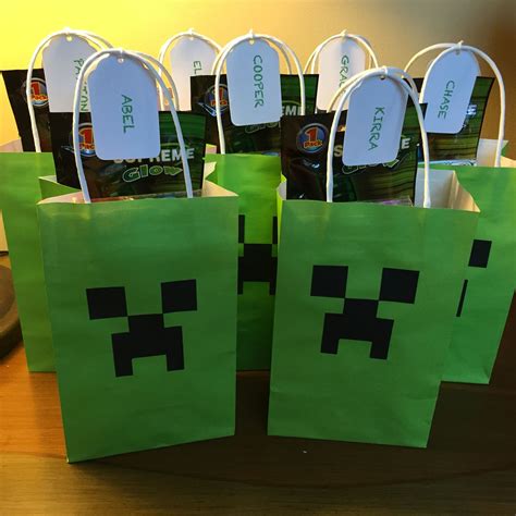 green paper bags with black faces on them