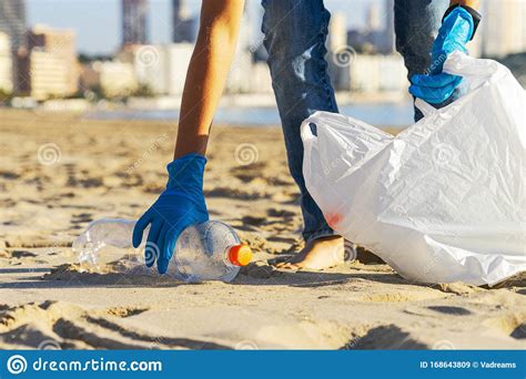 Clean Beach from Plastic. Hand Picking Up Plastic Bottle Trash from the Beach and Putting into ...