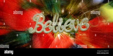 Decorations on Christmas Tree with Word Believe Stock Photo - Alamy