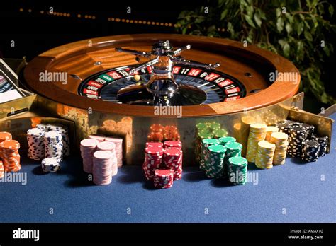 Roulette wheel with multiple stacks of gambling chips Stock Photo - Alamy