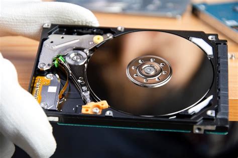 Premium Photo | Mechanic repairing hard drive hard drive it is a device for storing data