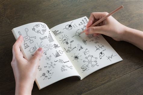 Free Photo | Person drawing on a notebook