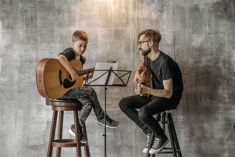 A Boy Playing an Acoustic Guitar · Free Stock Photo