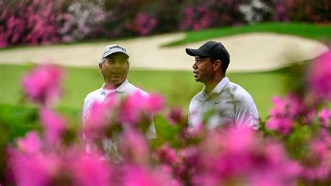 Masters champion Tiger Woods and Masters champion Fred Couples walk off the No.12 green during ...