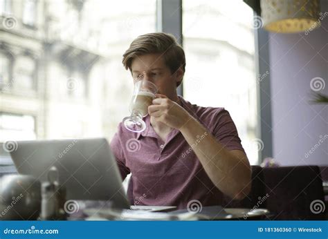 Male Drinking a Coffee while Using His Laptop Stock Photo - Image of person, young: 181360360