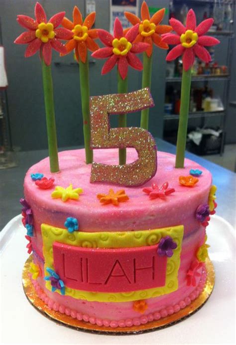 Round pink birthday cake with red flowers and stalks for 5-year-old ...