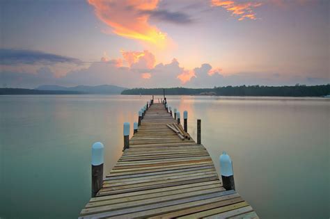 Brown Wooden Footbridge on Body of Water during Sunrise · Free Stock Photo