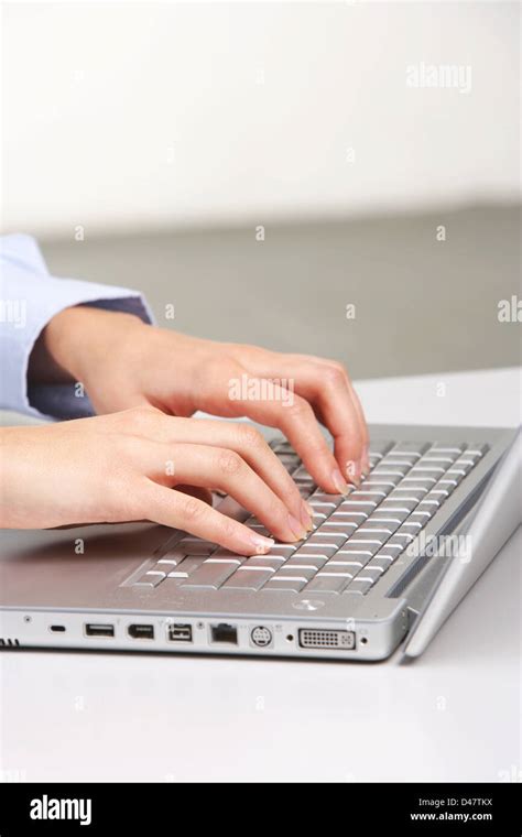 A person typing on a laptop keyboard Stock Photo - Alamy