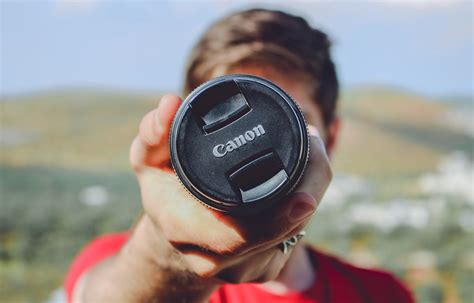 Man Holding Canon Dslr Camera · Free Stock Photo