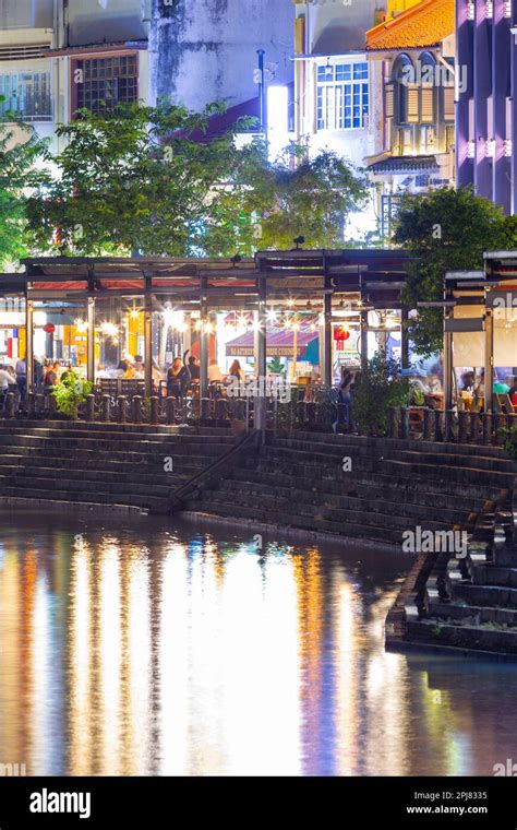 A night view of the Boat Quay on the Singapore River in Singapore. The ...