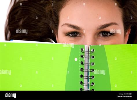 Beautiful woman peeping over book hi-res stock photography and images - Alamy