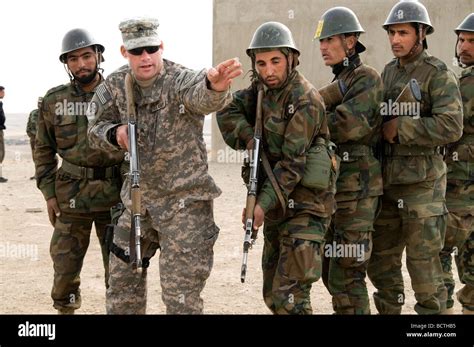 Afghan National Army recruits in training at the Kabul Military Training Center with a US Army ...