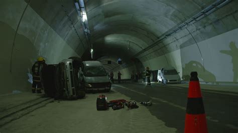 Car accident scene inside a tunnel, firefighters rescuing people from ...