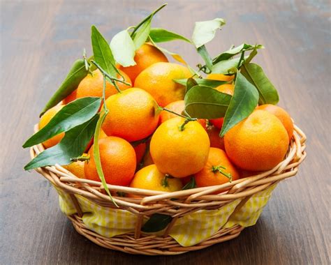 Premium Photo | Fresh mandarin oranges fruit with leaves on wooden table