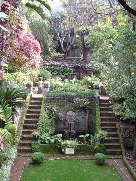 an outdoor garden with steps leading up to the top floor and lots of ...