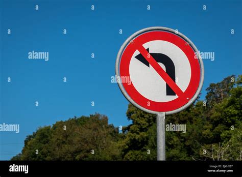 No left turn sign against blue sky. Traffic signs. Prohibited from ...