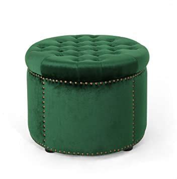 a green round ottoman with studded trimmings on the top and bottom, sitting in front of a white ...