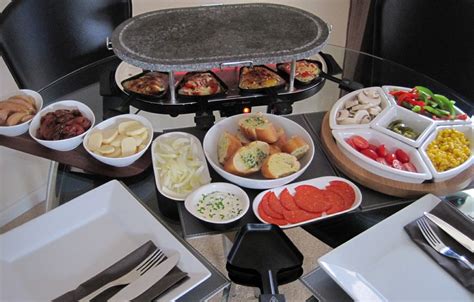 an assortment of food is being prepared on a table with silverware and utensils