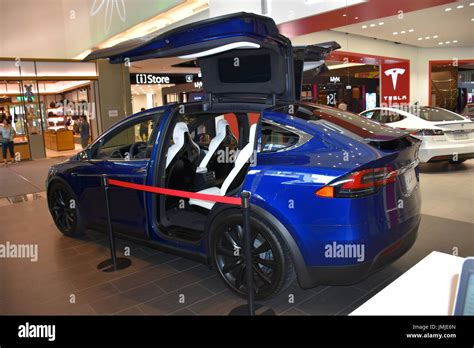 A blue Model X Tesla with open gull wing doors in Taipei, Taiwan show ...