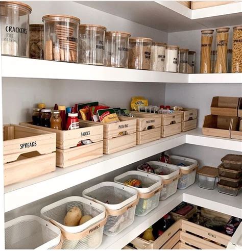 an organized pantry filled with lots of food and storage bins on the ...