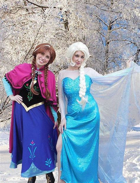 two women dressed as disney princesses in the snow