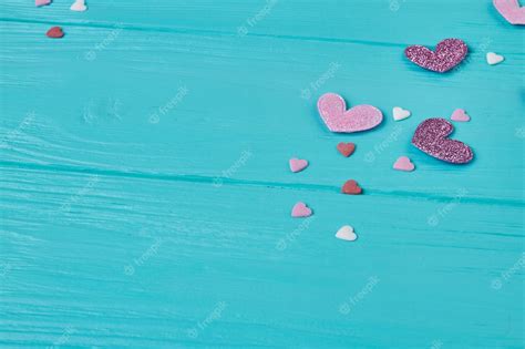 Premium Photo | Pink and purple hearts on blue wood