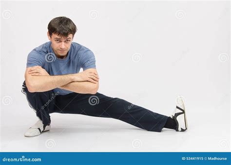 Sportsman Squatting Muscles Pulling the Left Foot Stock Image - Image of shirt, fitness: 53441915