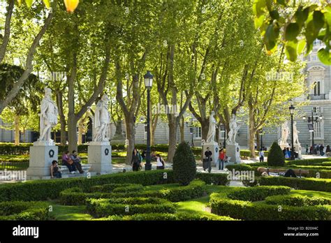 SPAIN Madrid Statues lining sidewalk through gardens of Plaza de ...