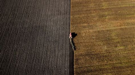 Premium Photo | Tractor plowing the field