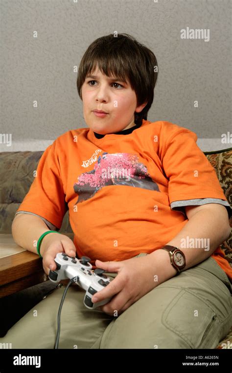 portrait of a young boy playing playstation Stock Photo - Alamy