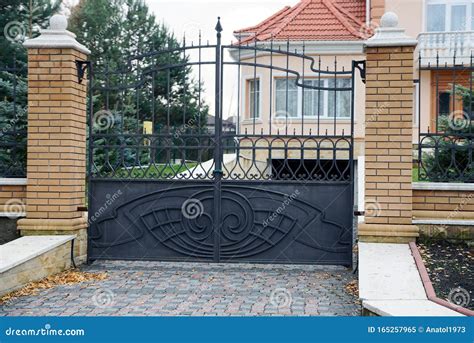 Black Wrought Iron Gate and Part of a Brown Brick Fence Stock Image ...