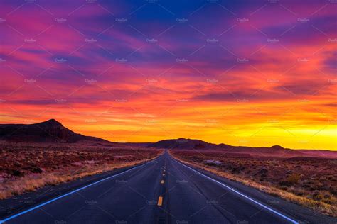 Dramatic sunset over an empty road in Utah | Nature Stock Photos ~ Creative Market