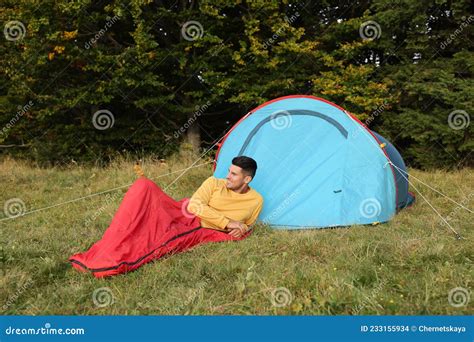 Man in Sleeping Bag Near Camping Tent Outdoors Stock Photo - Image of ...