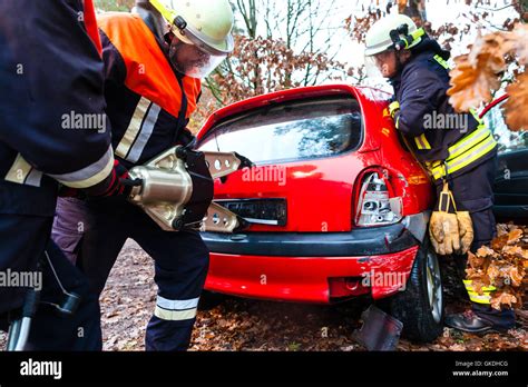 accident - fire rescue accident victims from car Stock Photo - Alamy