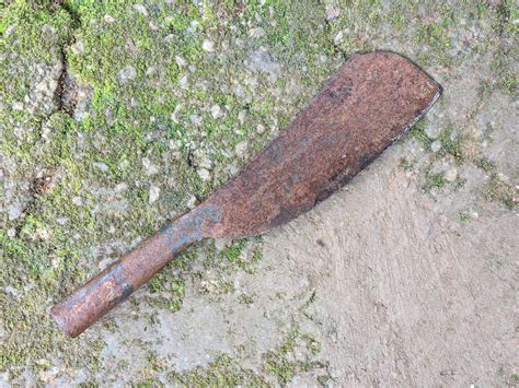 Premium Photo | An old rusty machete on the ground