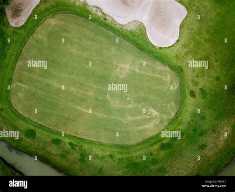 aerial view of golf hole with flag in golf course. aerial view by ...