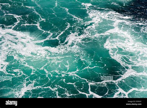 Turquoise green Seawater with sea foam as background Stock Photo - Alamy