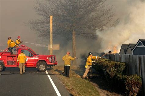 N.J. forest fire that destroyed buildings, damaged homes still burning. Firefighter critically ...