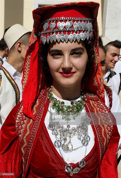 An Albanian dancer, in traditional costume, waits for the start of a ...